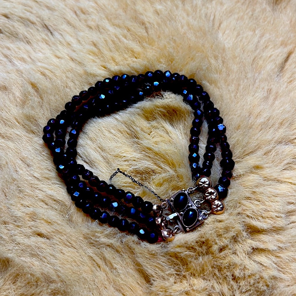 Ruby colour ornate closure beaded bracelet
